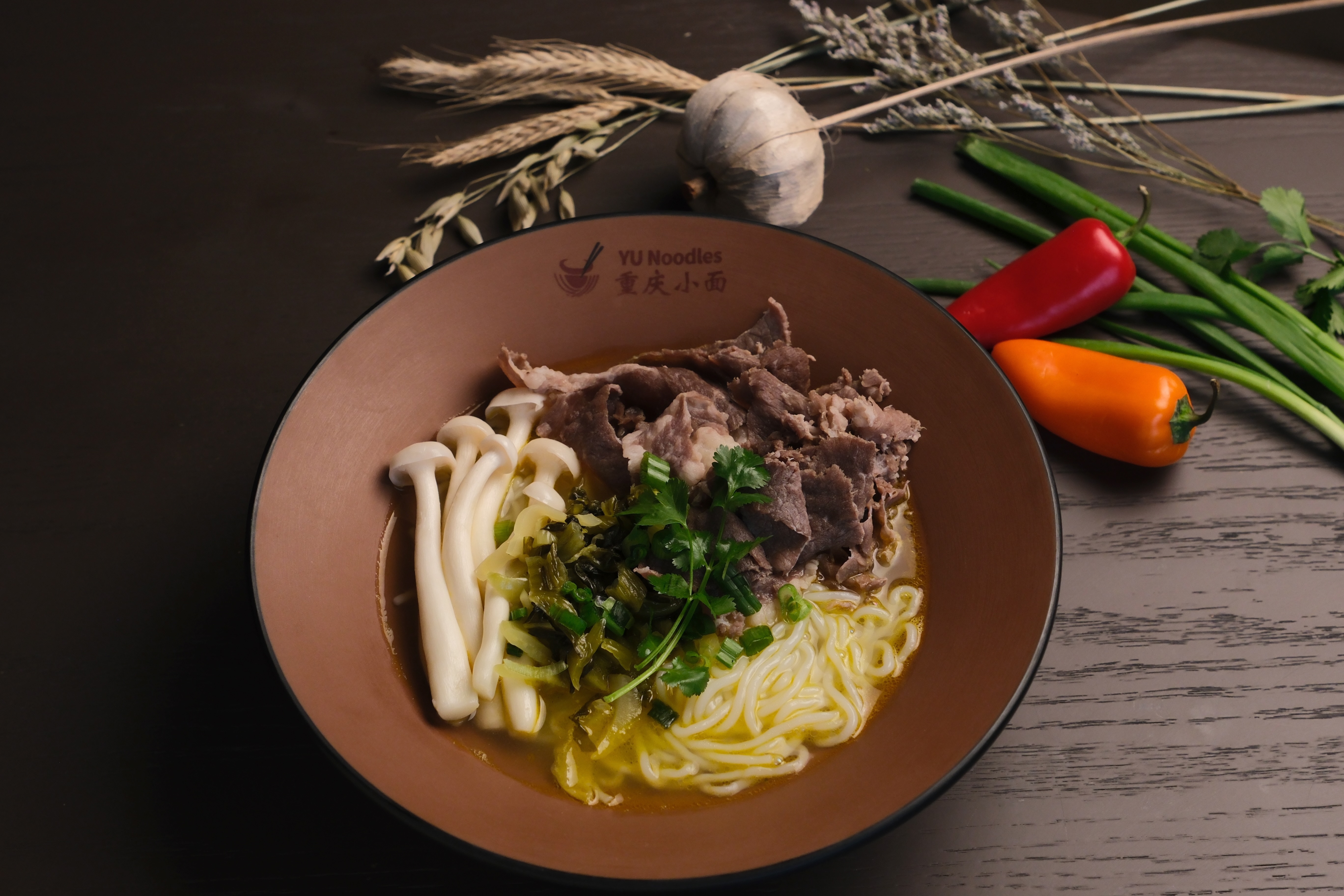 A beef noodle soup bowl from YU Noodles